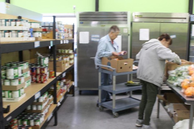 Volunteers Sheryl Crawford (left) and Diane Schoenstein organize food at the St. Vincent de Paul Food Bank. (Jason Chaney/Central Oregonian)